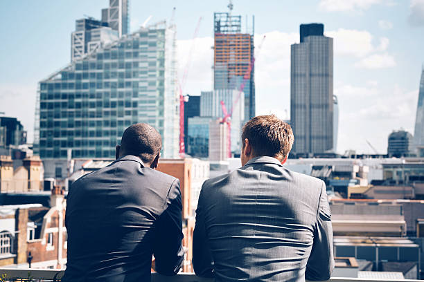 two-businessmen-looking-at-city-scape-picture-id533443569